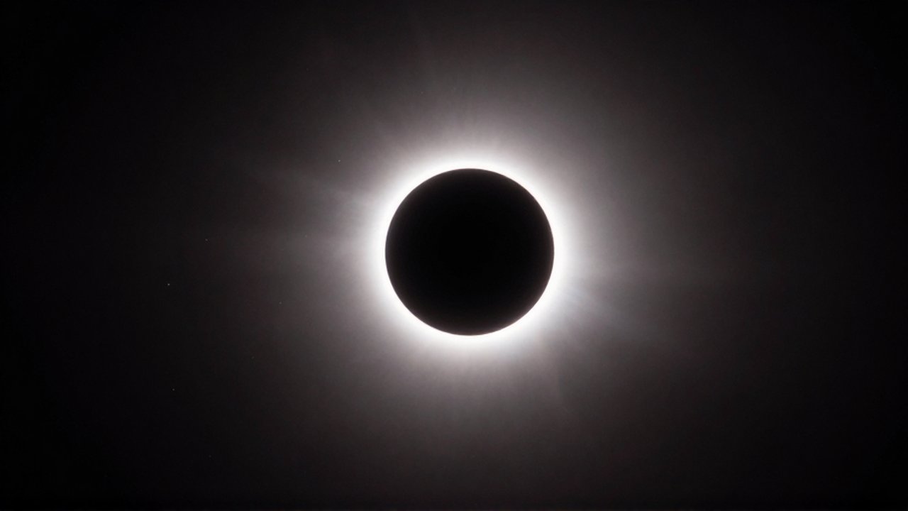 Eclipse solar total con la corona solar brillante rodeando la silueta negra de la luna.