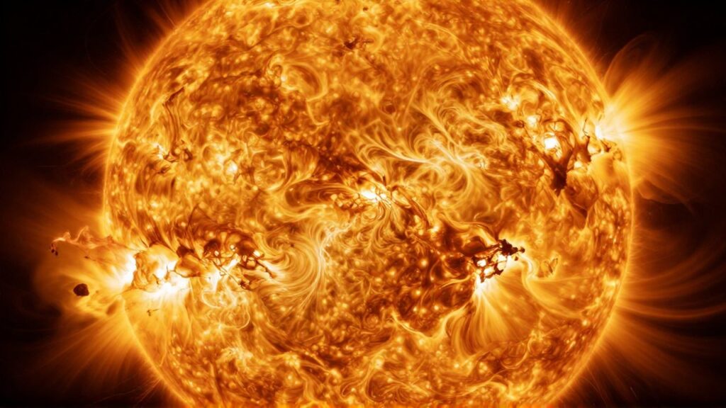 Superficie de una estrella masiva con células de plasma ardiente en tonos dorados y naranjas.