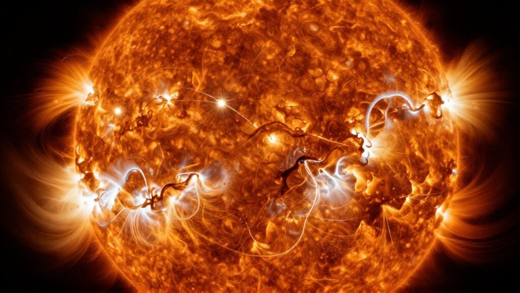 Superficie ardiente de una estrella con burbujas de plasma incandescente y filamentos magnéticos brillantes.